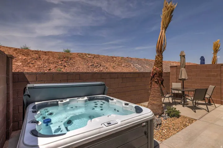 Outdoor spa situated on a concrete patio with an integrated gravel bed