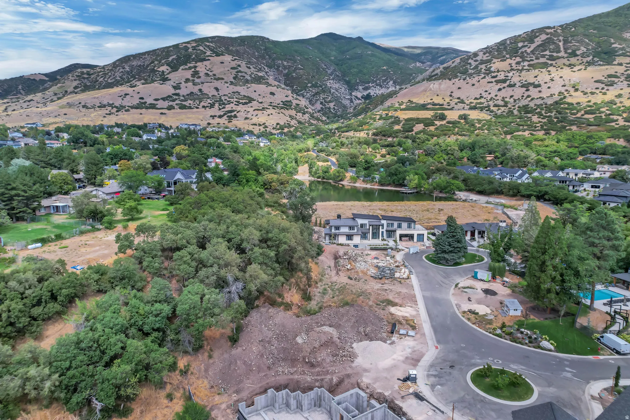 Aerial perspective showcasing a developing residential area with mountainous terrain backdrop