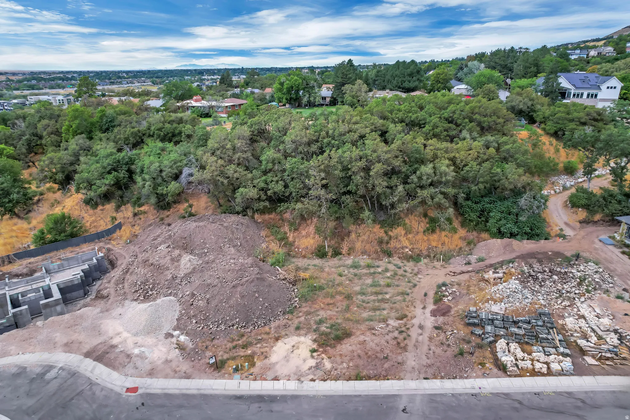 Developing property site featuring excavated land and partial foundation work