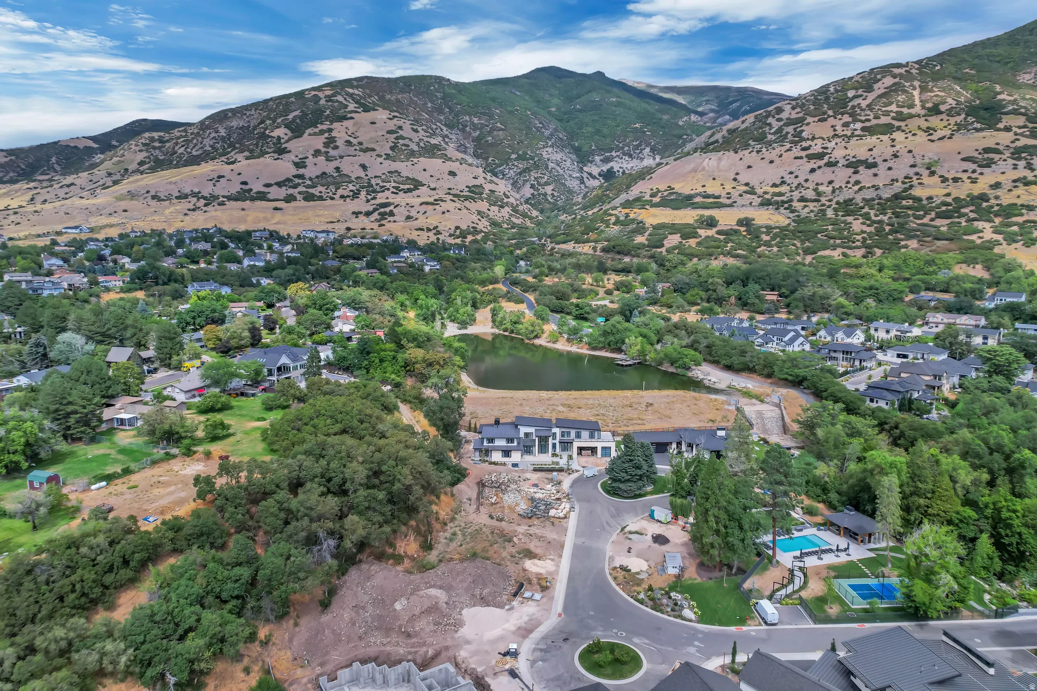 Aerial perspective featuring a cul-de-sac with surrounding residences, including a property with a private swimming pool and a separate spa