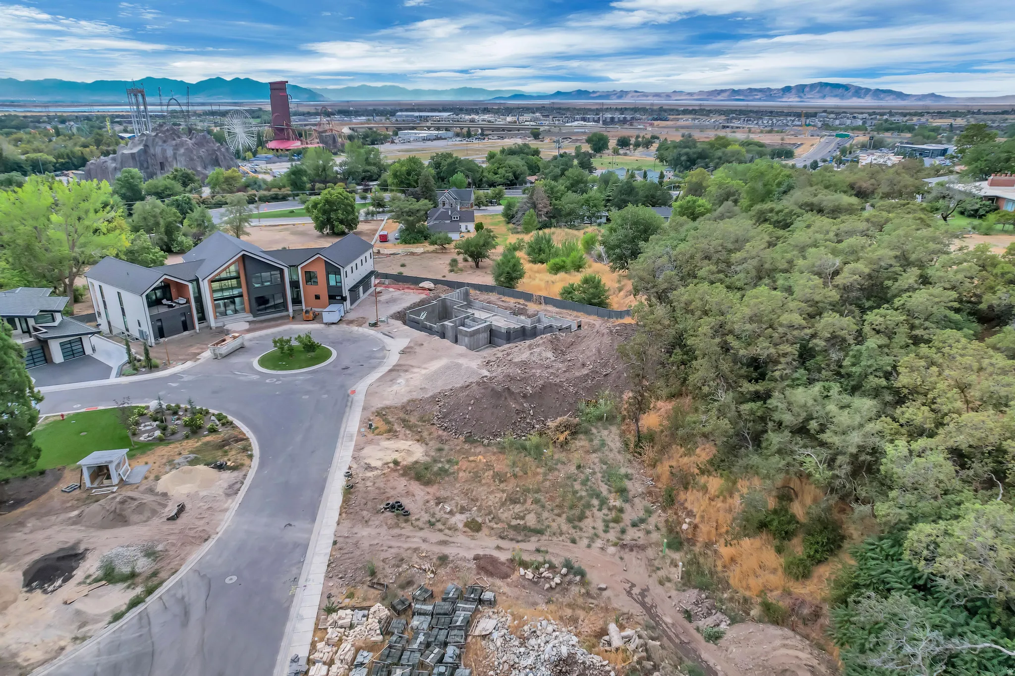 Expansive land parcel featuring existing new construction and additional building foundations