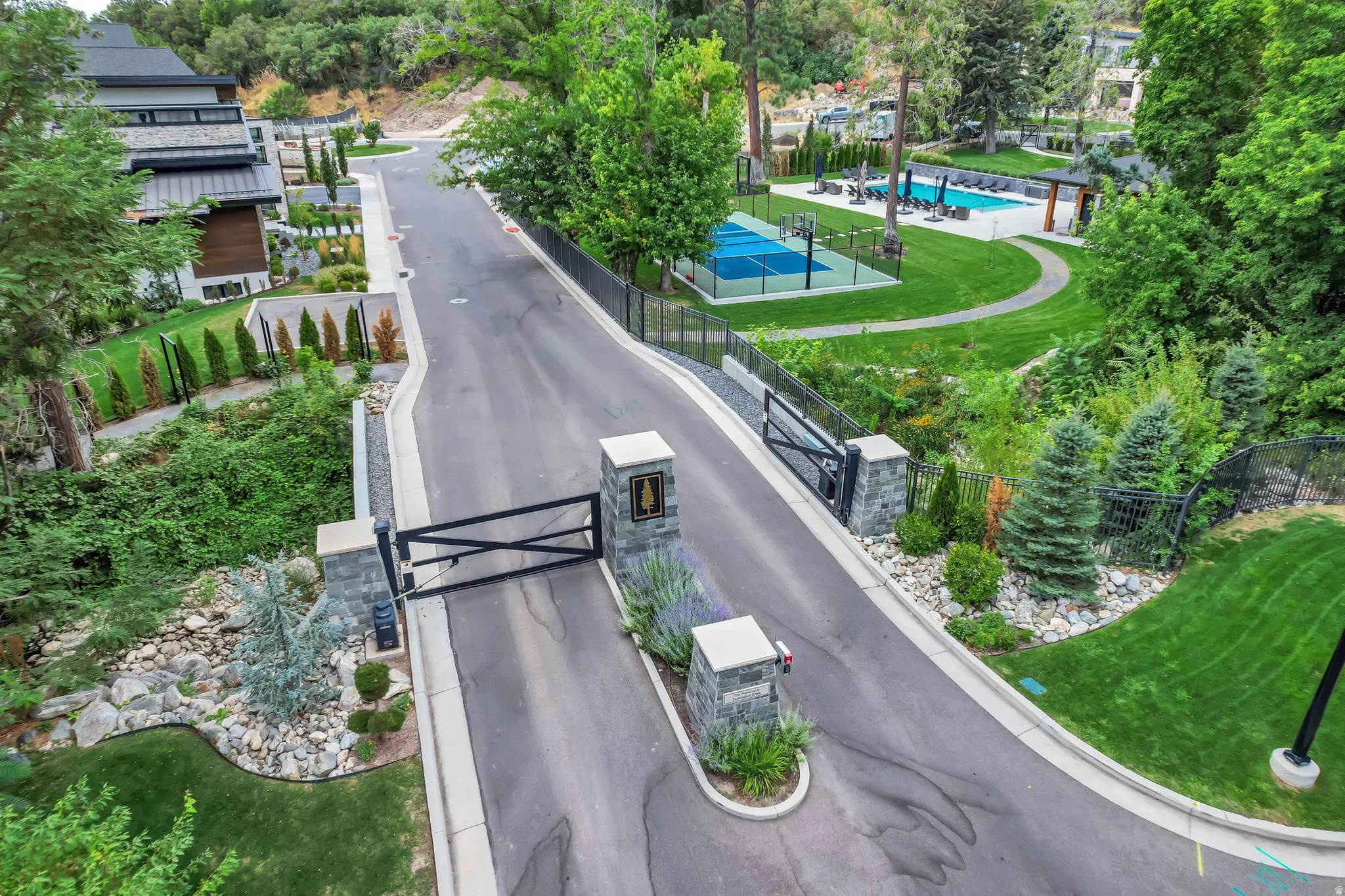 Paved entry drive with stone pillars and wrought iron gates