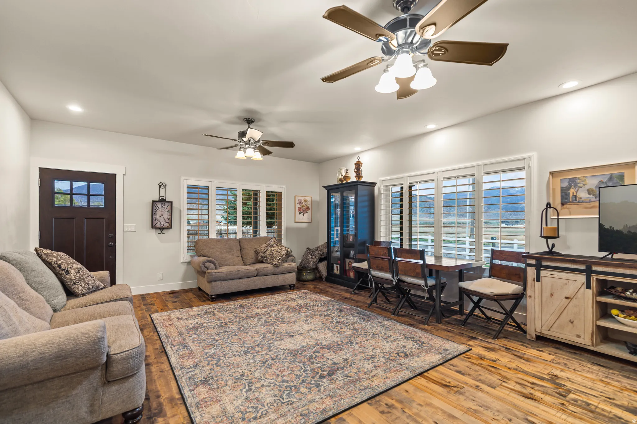 Open concept living space featuring wood-finish flooring, recessed lighting, and ceiling fans
