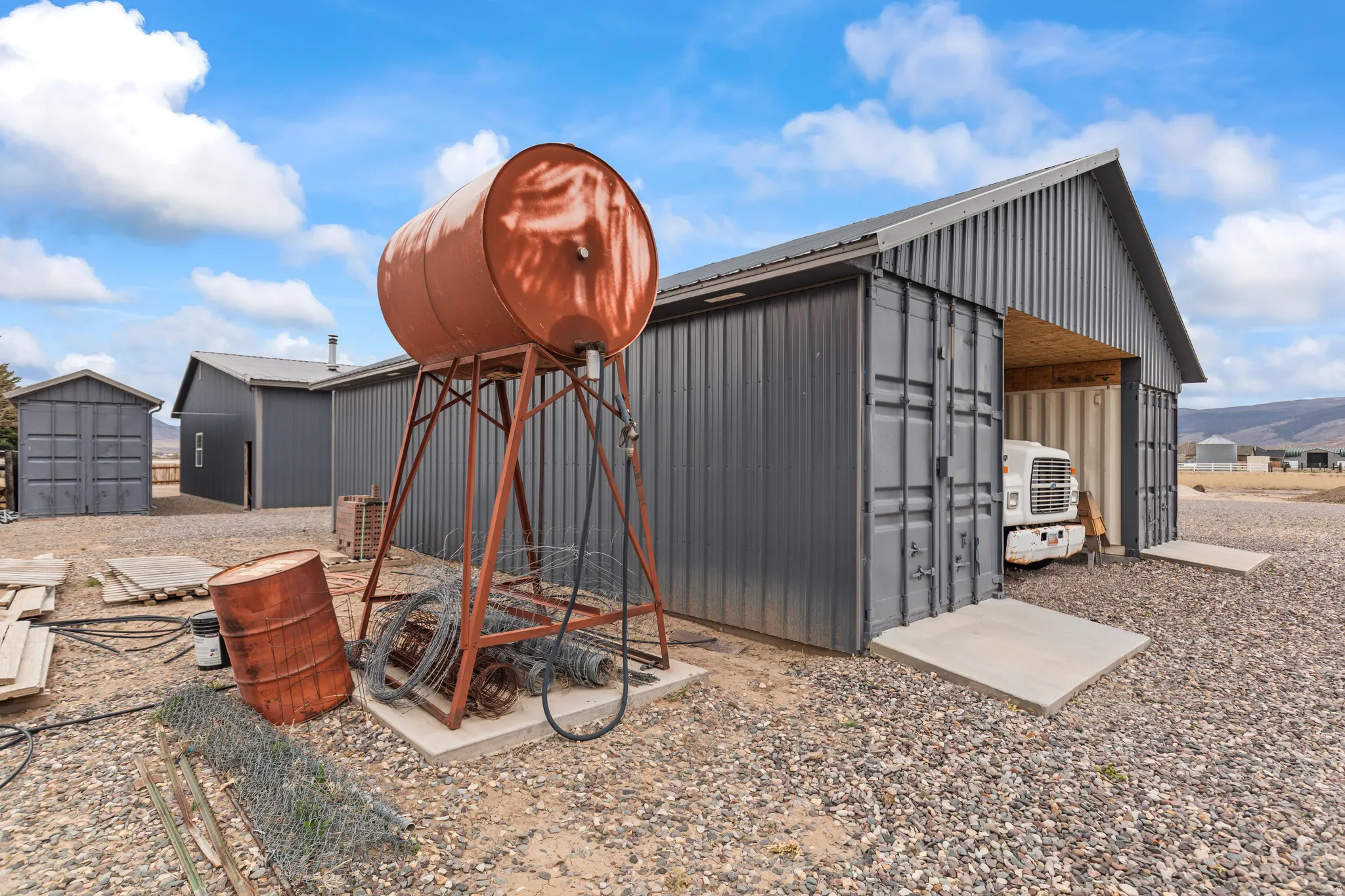 Corrugated metal structures with a gravel ground surface