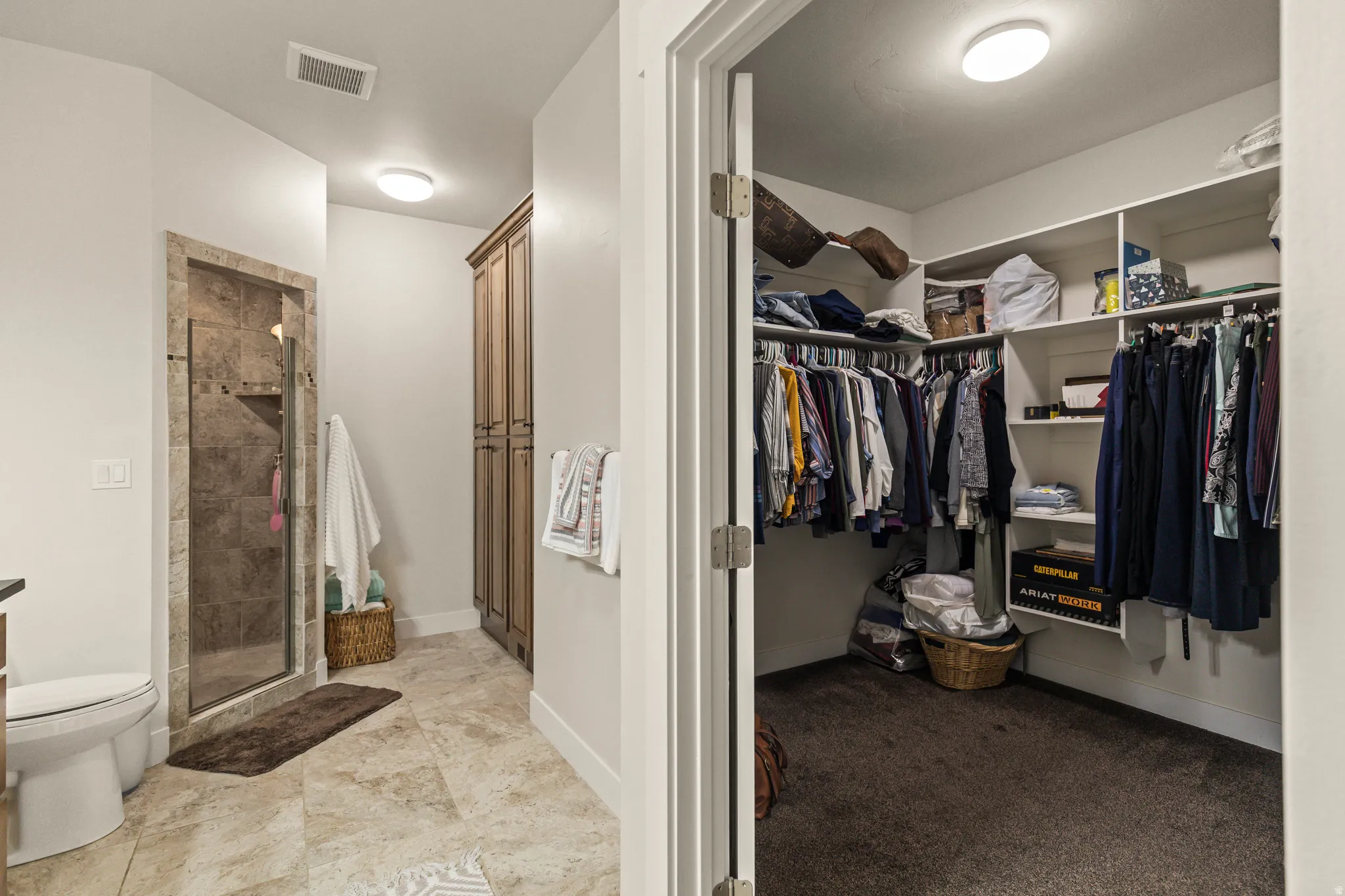 Spacious walk-in closet with extensive built-in shelving and clothing rods