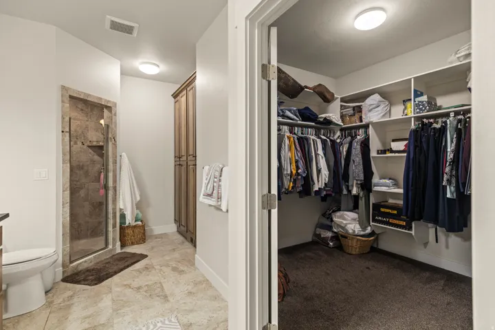Spacious walk-in closet with extensive built-in shelving and clothing rods