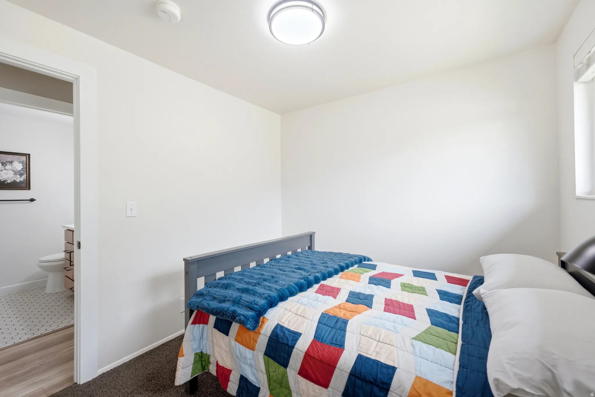White walls and neutral carpeting provide a versatile backdrop for furnishings