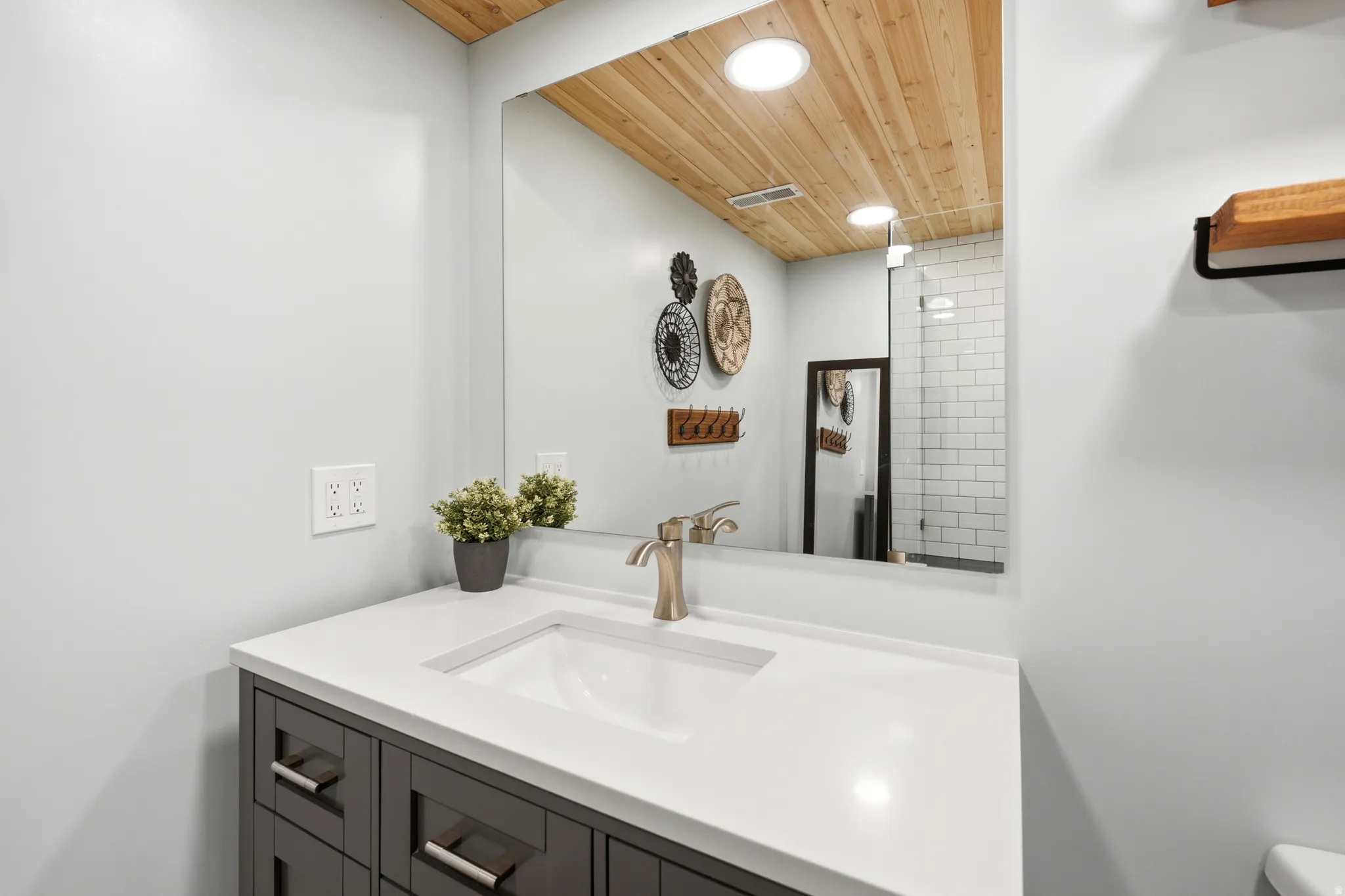 Bathroom vanity with a white countertop and undermount sink