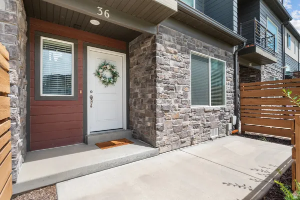 Entryway featuring stone veneer facade and horizontal wood siding