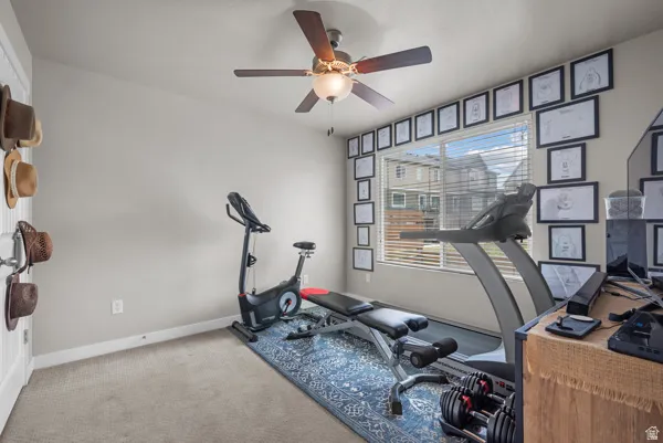 Room featuring light gray painted walls, a ceiling fan with integrated lighting, and a large window with horizontal blinds