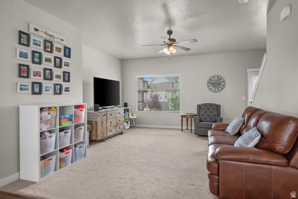 Spacious living area featuring neutral carpeting and light-toned walls