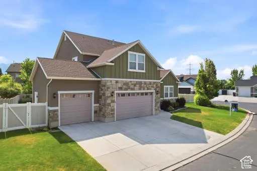 Contemporary exterior featuring a combination of horizontal siding, vertical board and batten siding, and stone accents