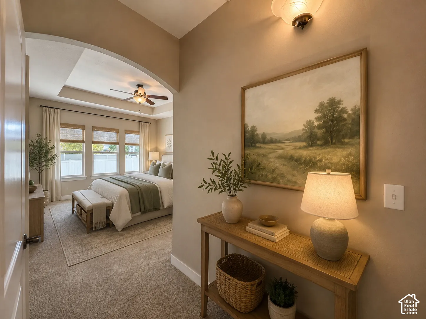 Coved ceiling with a ceiling fan, three large windows with blinds, and carpeted flooring. Ai staged