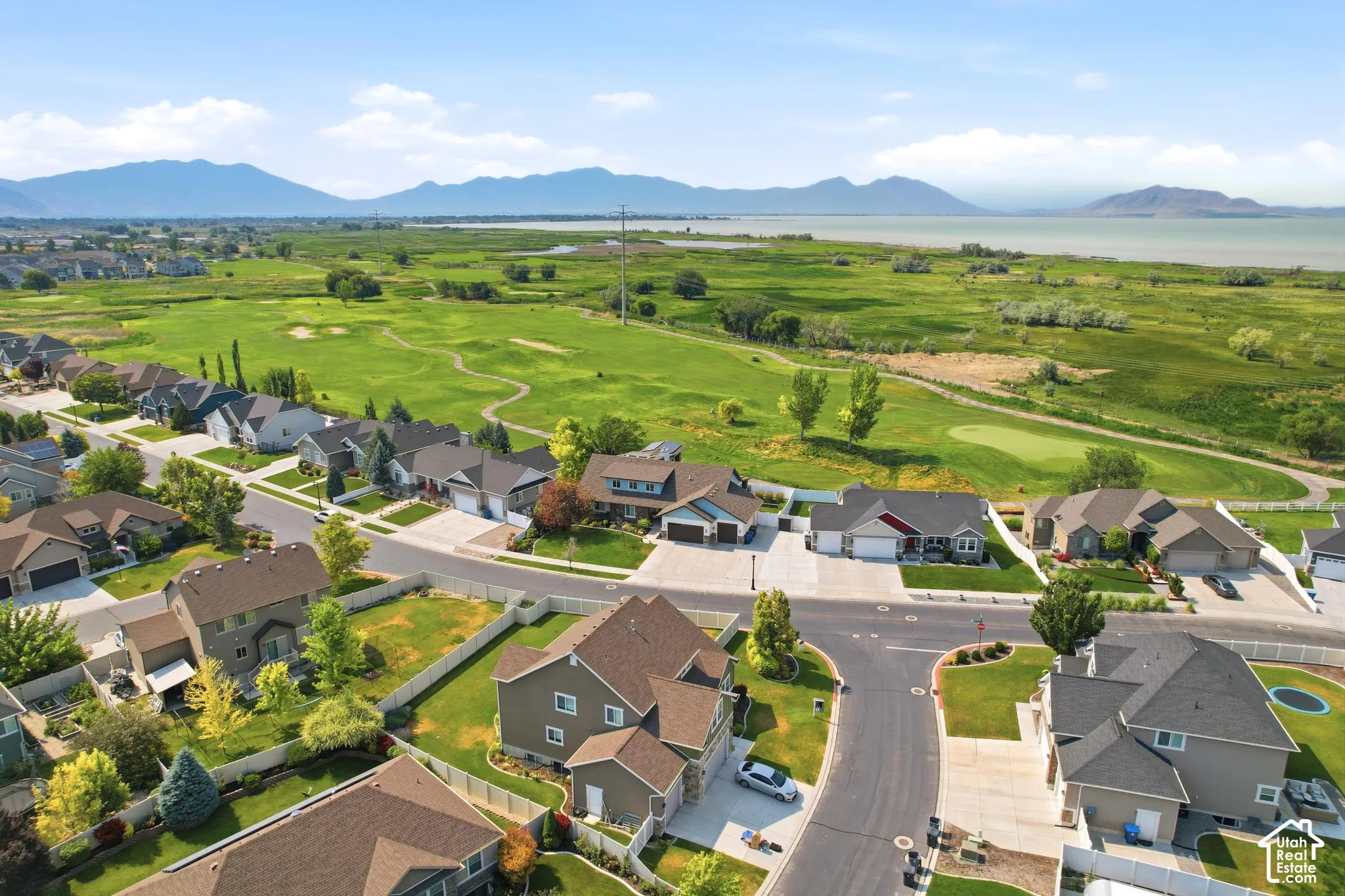 Aerial perspective of a residential neighborhood featuring single-family homes with individual driveways and landscaped yards
