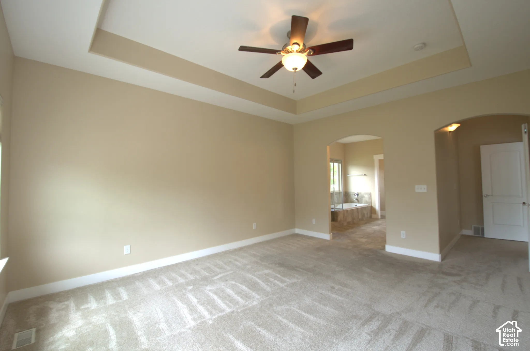 Master bedroom with tray or coffered ceiling