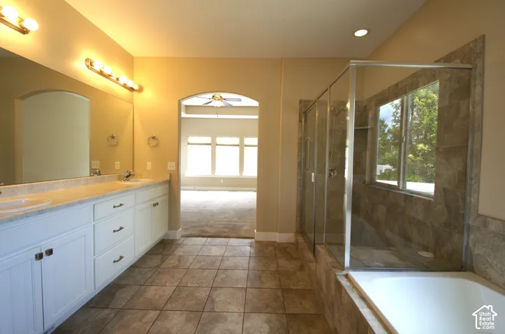 Master Bathroom featuring a dual vanity with white cabinetry, a large mirror, and tiled flooring