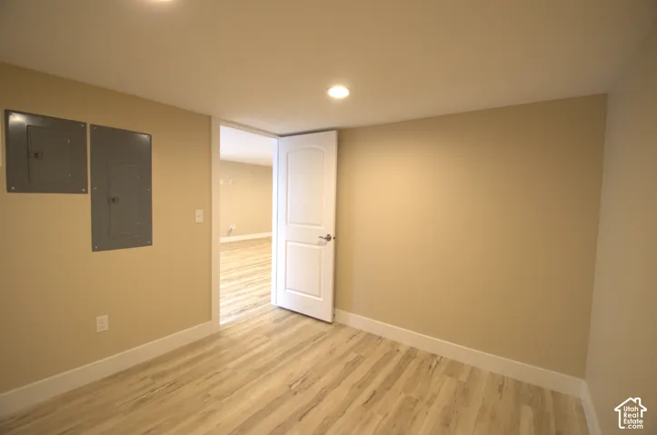 Room featuring wood-finish flooring, recessed lighting, and a neutral wall color