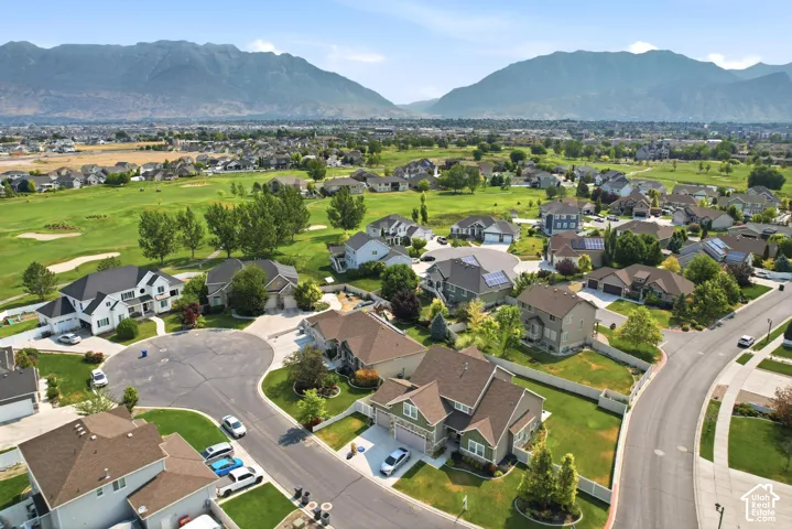 Residential neighborhood with cul-de-sac layout, featuring a variety of single-family homes with pitched roofs and manicured lawns