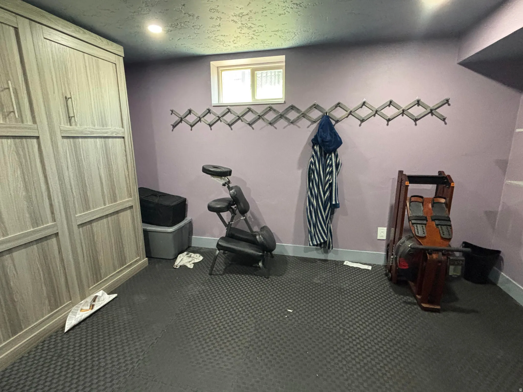 Murphy bed with a wood-finish, light purple wall paint, and recessed ceiling lighting