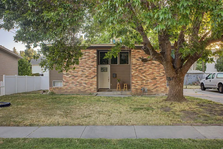 Brick and siding facade with a white front door featuring glass panels