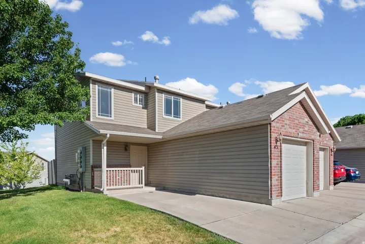 Two-story exterior with light-toned siding and brick accents