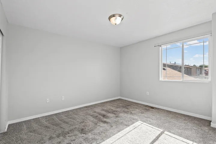Neutral gray wall paint and clean gray carpeting