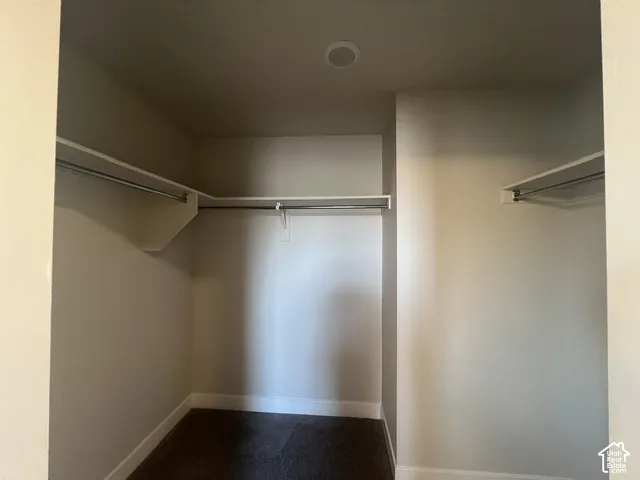Walk-in closet with built-in shelving and hanging rods