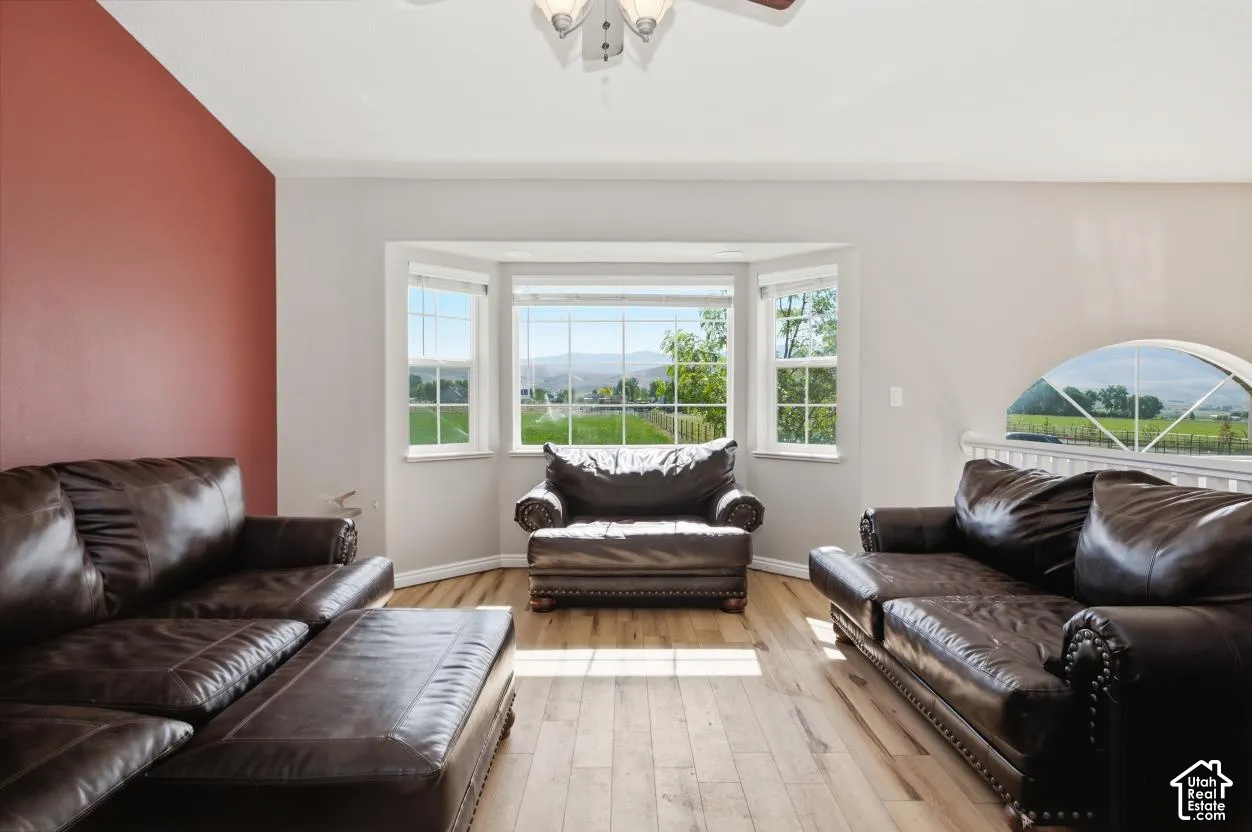 Living space featuring light wood-finish flooring and a distinctive accent wall