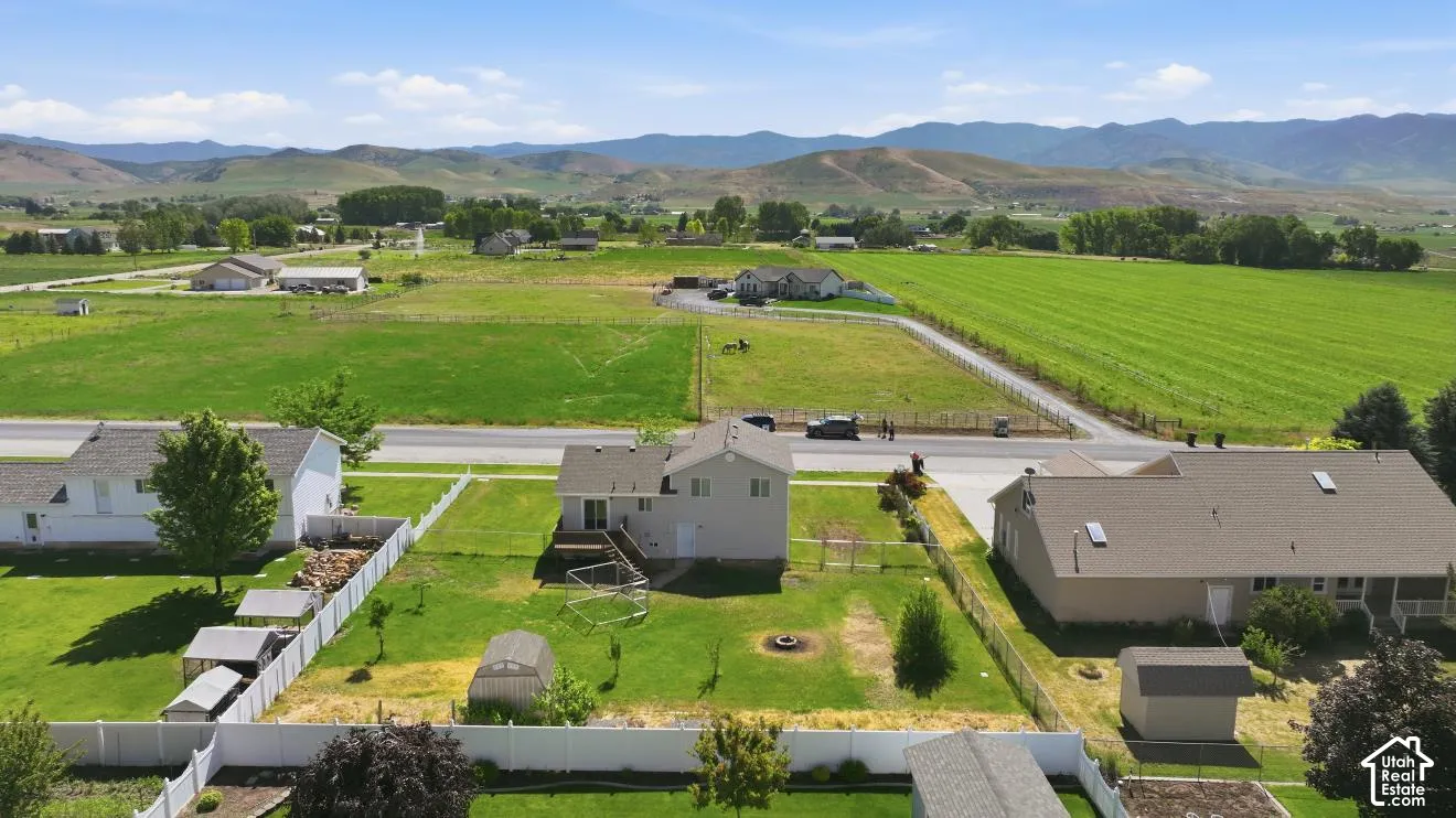 Rear exterior featuring a deck, a fenced yard, and a greenhouse
