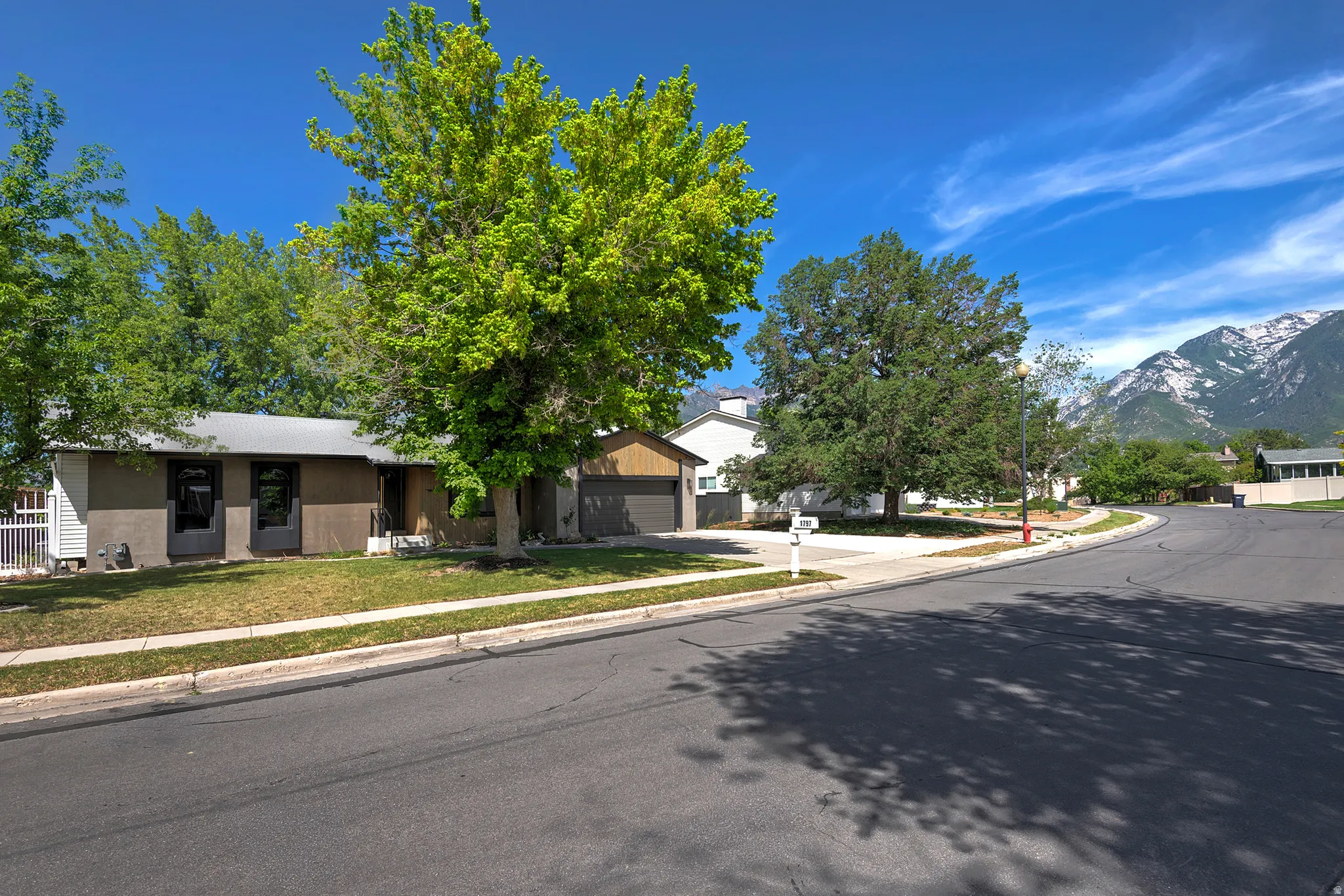 Single-story residence featuring a gray exterior finish and a two-car garage