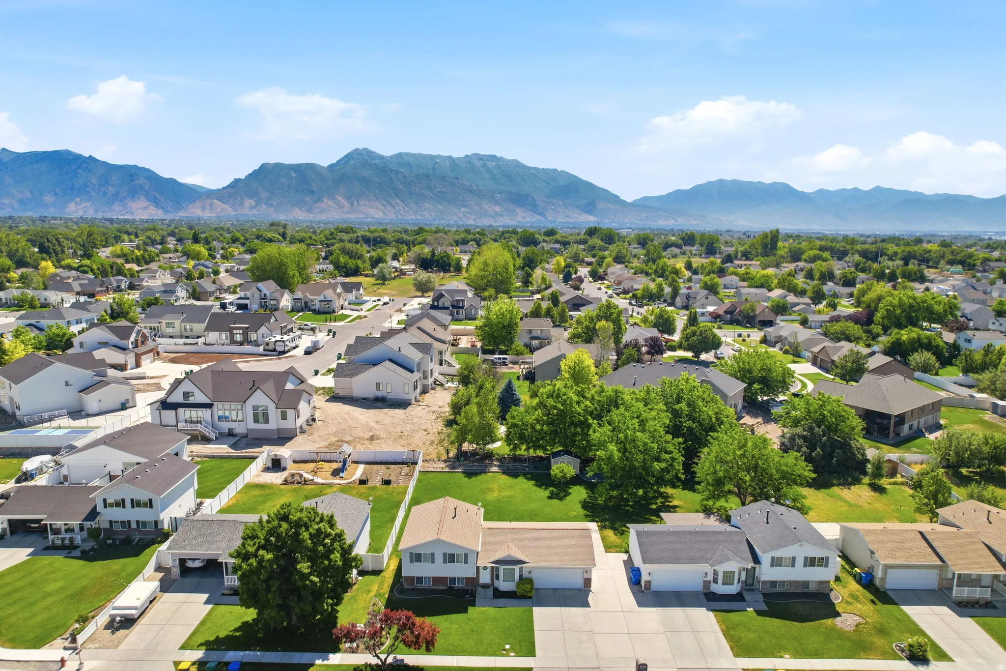 Suburban neighborhood featuring established residential properties and new construction amidst expansive green landscaping