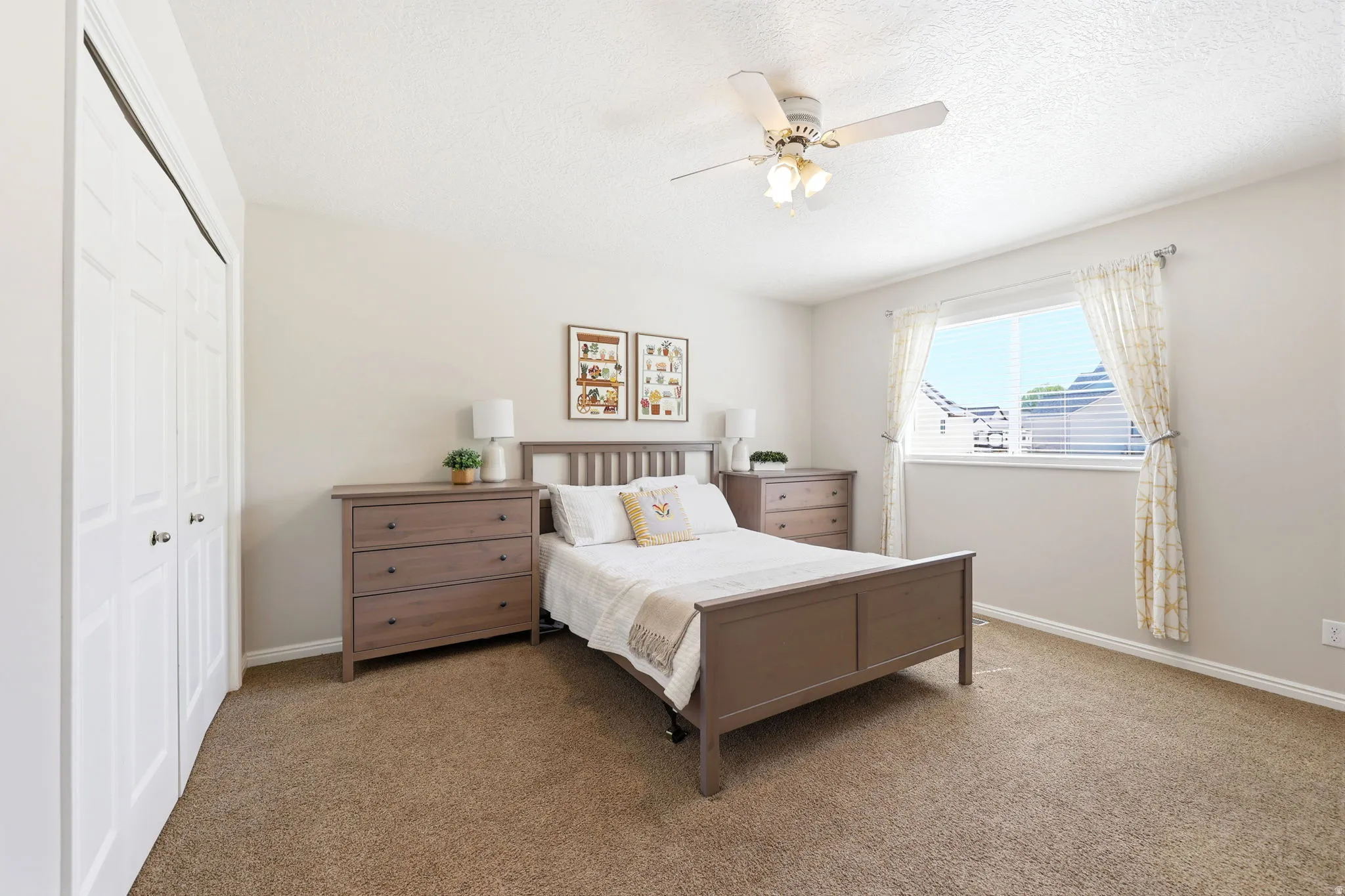 Wall-to-wall carpeting and a ceiling fan with integrated lighting