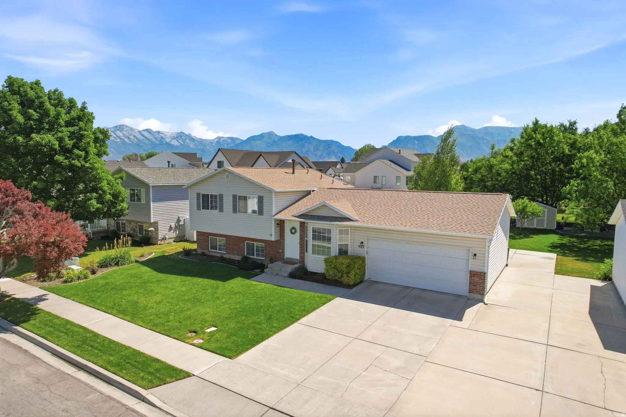 Traditional two-story residence with a tan shingle roof