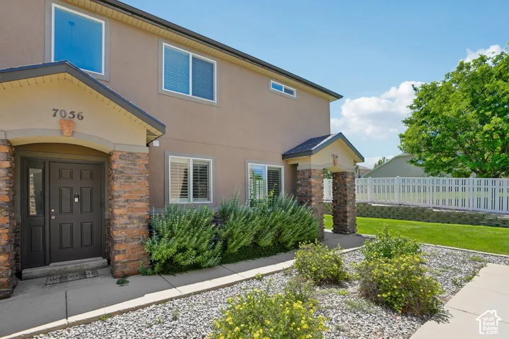 Stucco exterior with stone veneer accents, offering a two-story design