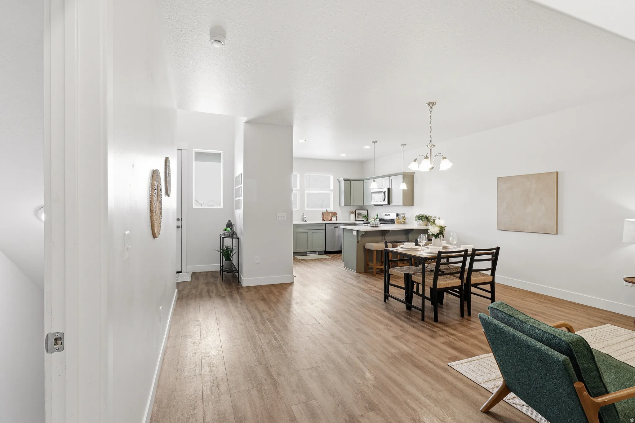 Open concept living area with wood-finish flooring