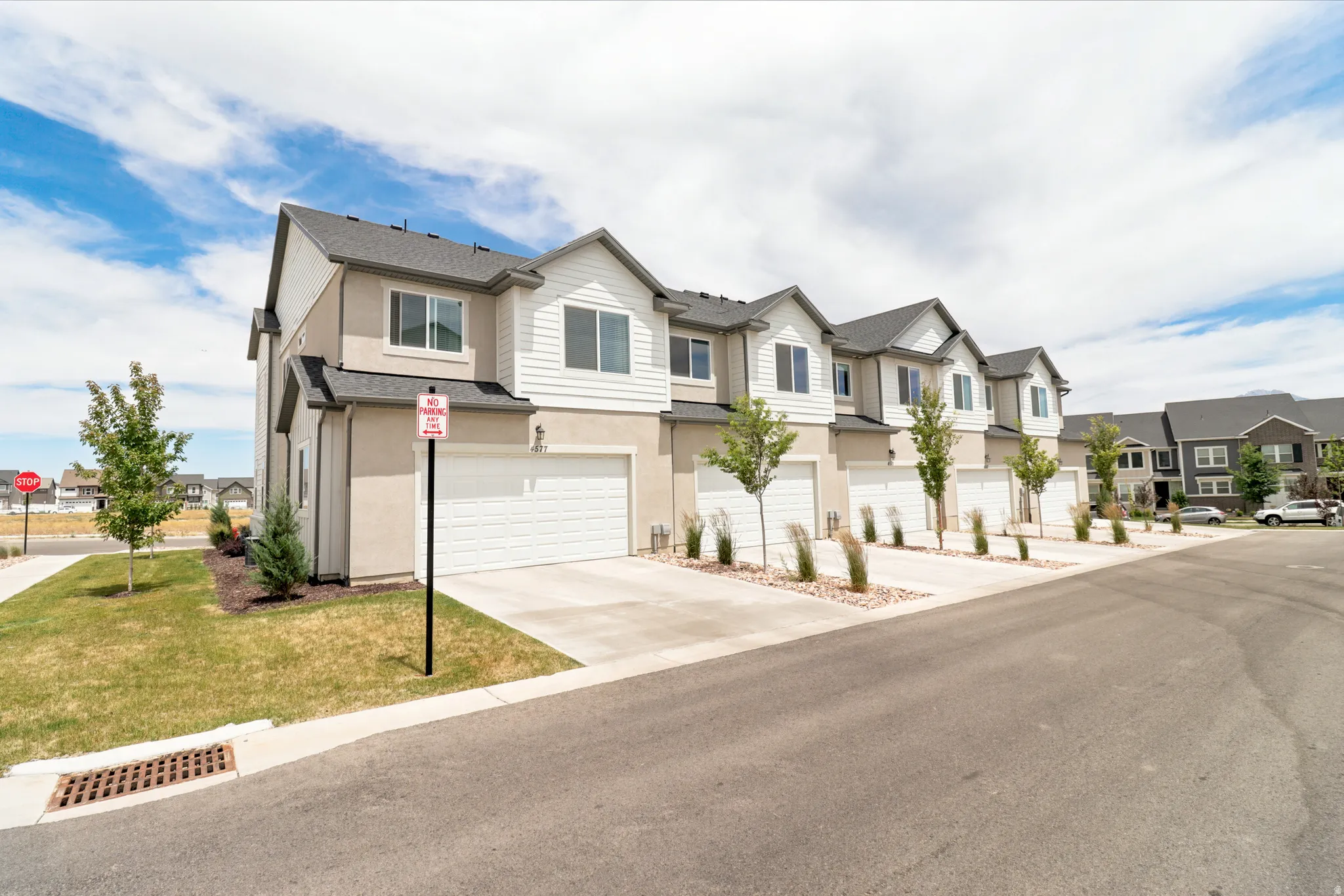 Modern townhome row featuring stucco and horizontal siding exteriors