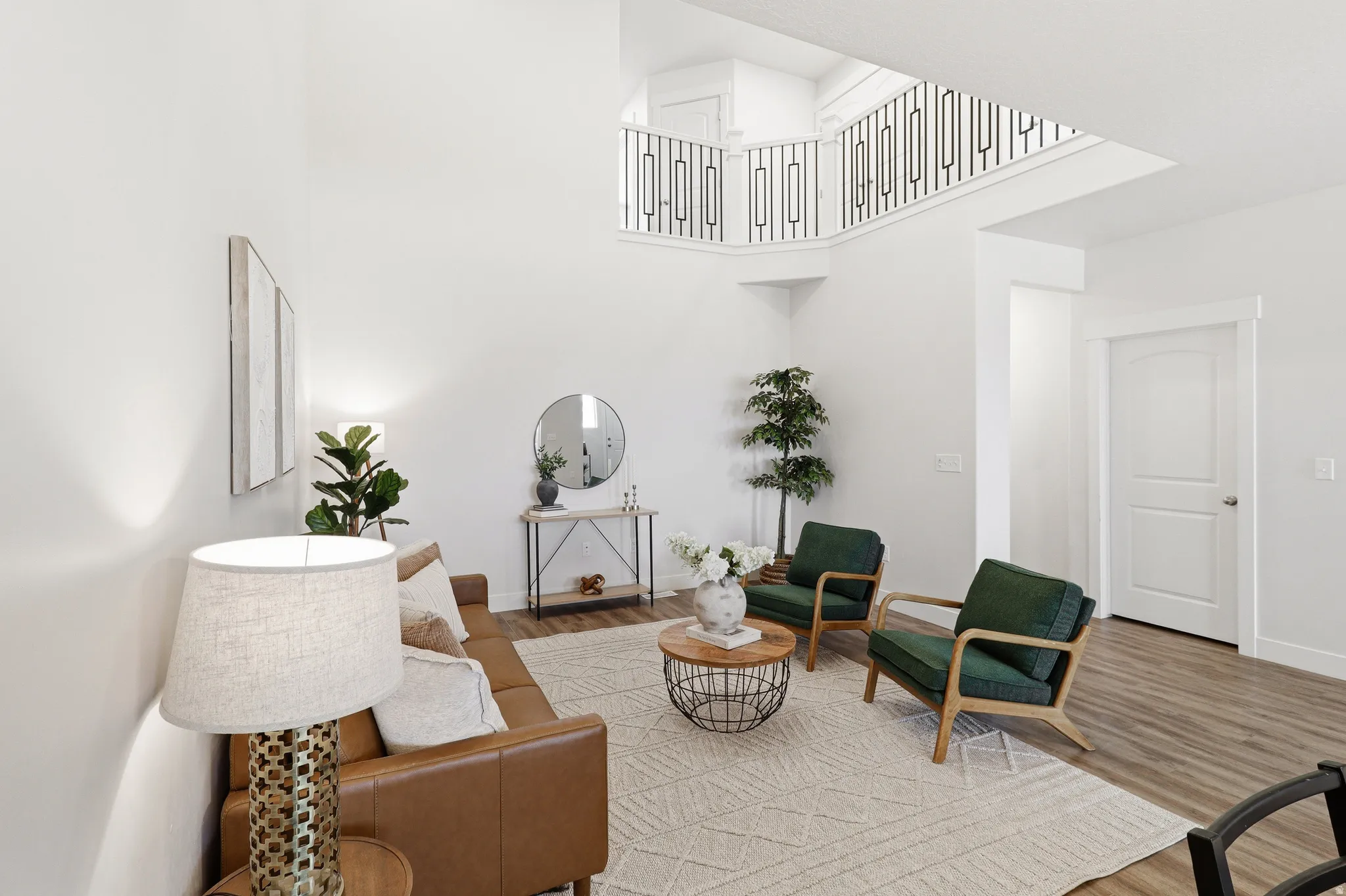 Two-story living area featuring a vaulted ceiling and an open-concept upper-level railing
