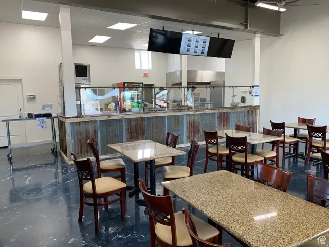 Spacious commercial interior featuring a service counter with corrugated metal paneling and a quartz-finish countertop