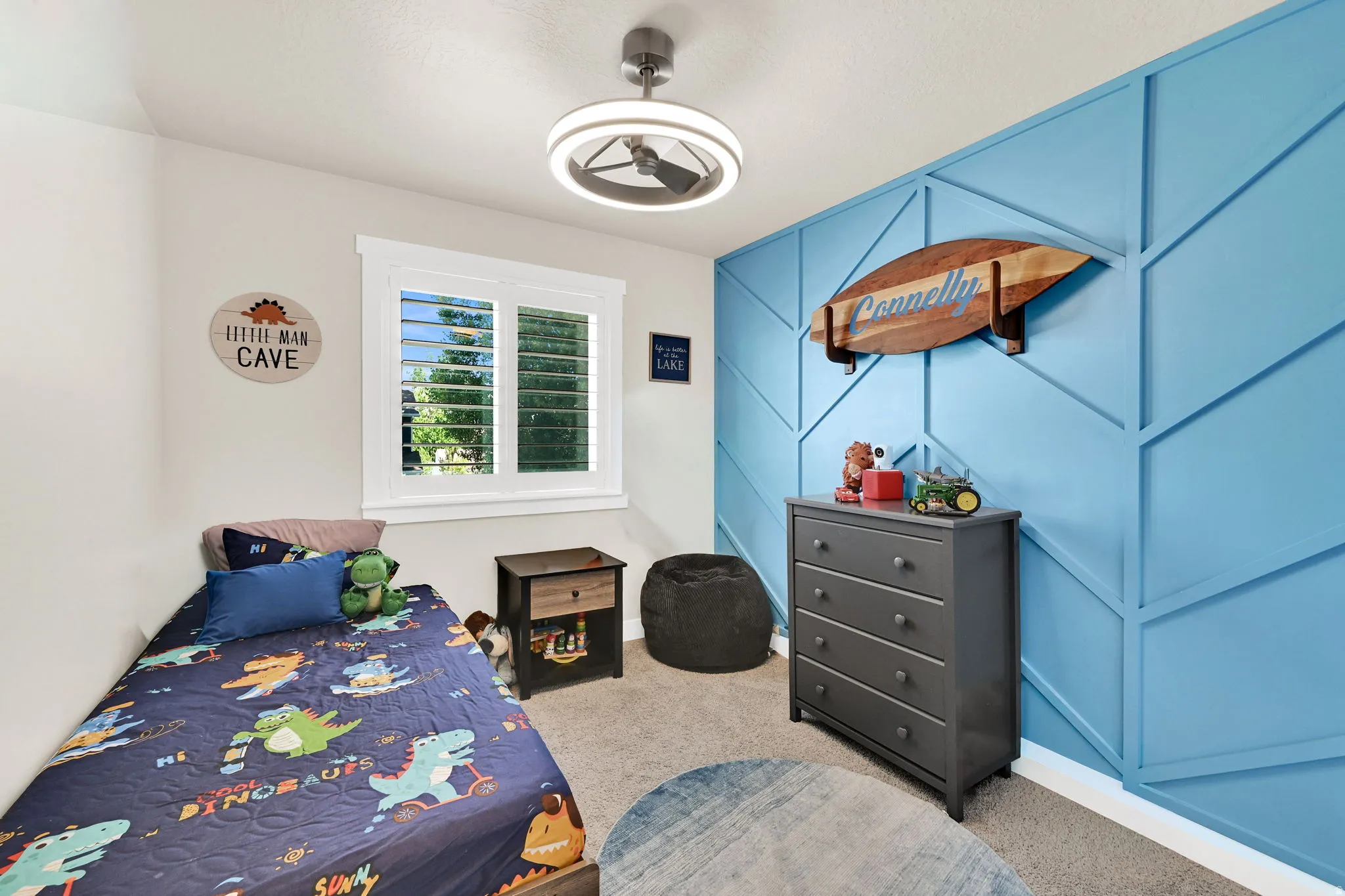 Room 2- featuring a  accent wall, window with plantation shutters, ceiling fan with integrated lighting, carpet and light-toned wall paint