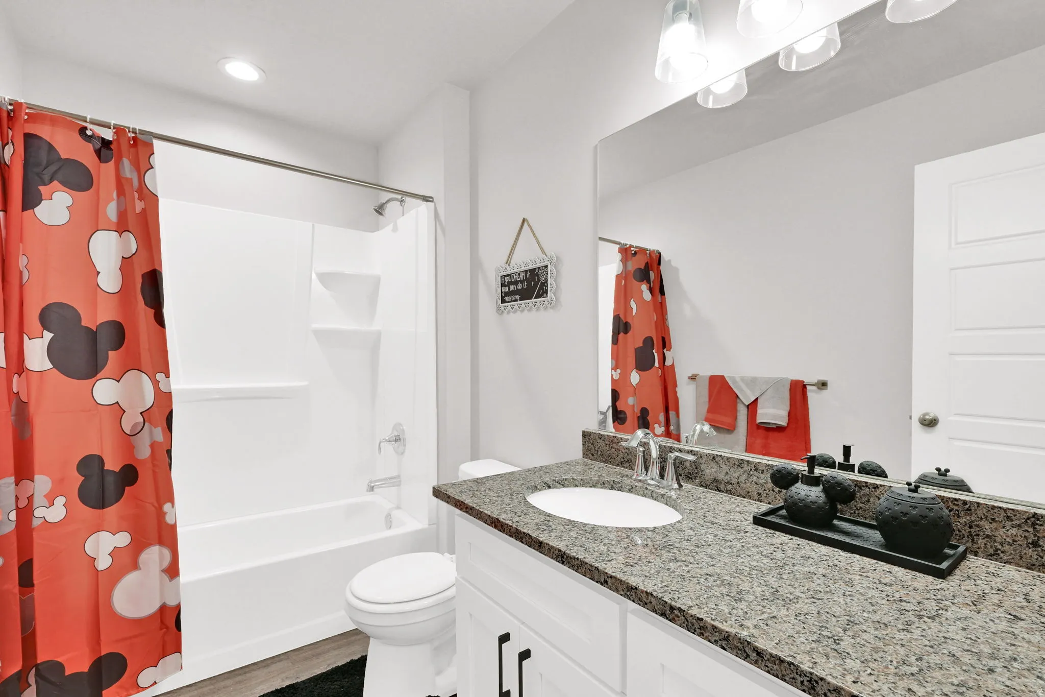 Bathroom featuring a full-size tub and shower combination with a white surround