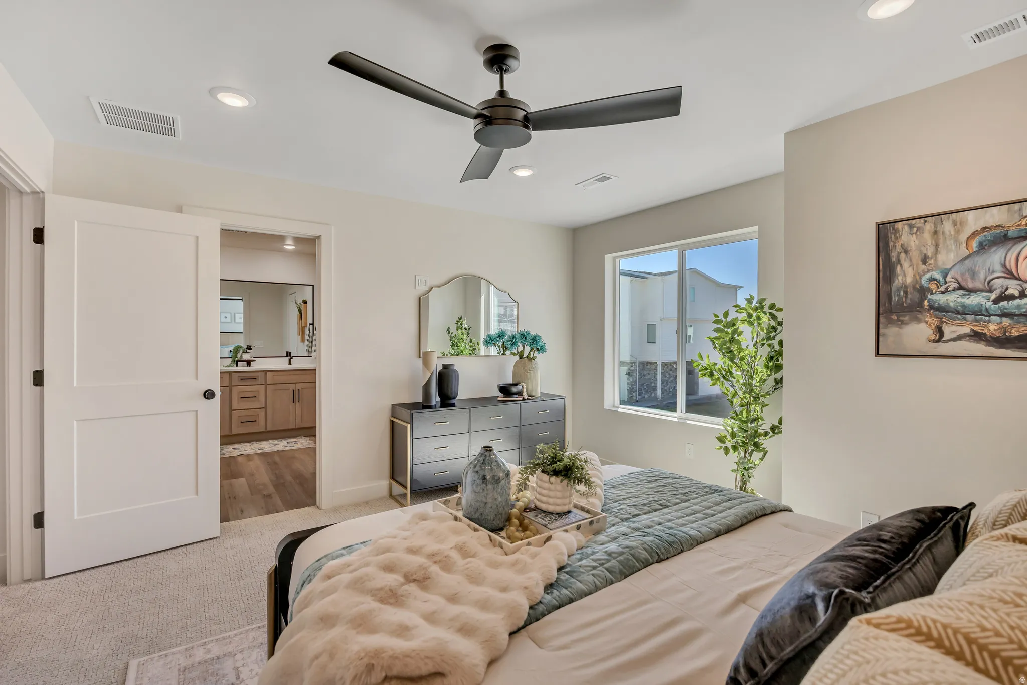 Bedroom featuring a ceiling fan with integrated lighting, recessed ceiling lights, and a window providing natural light
