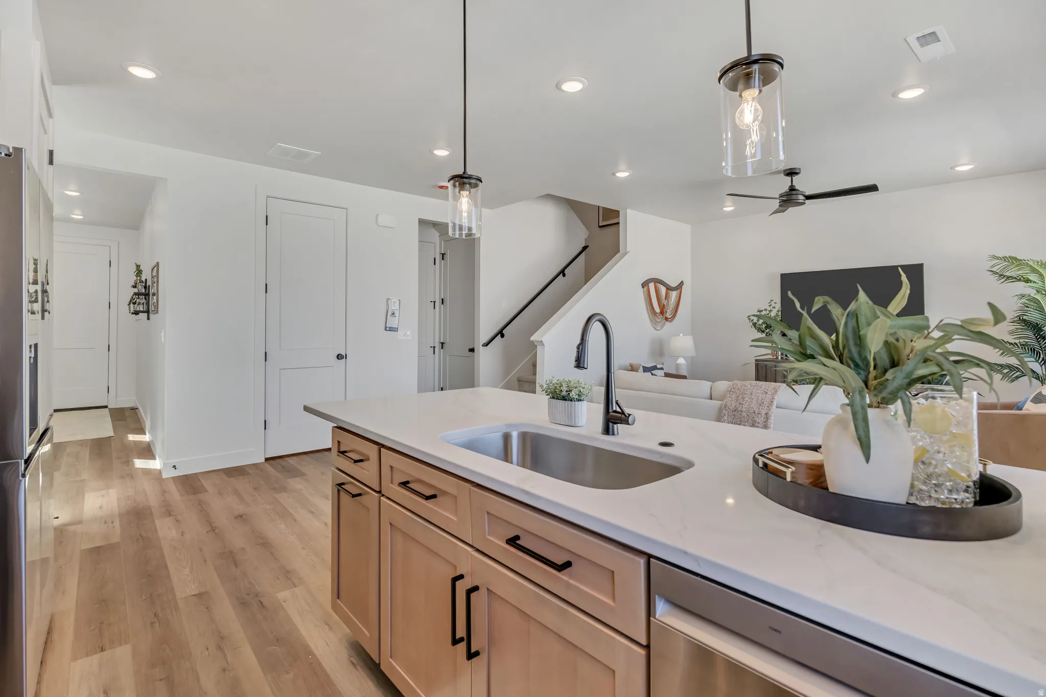 Kitchen island featuring a stainless steel undermount sink and matte black faucet