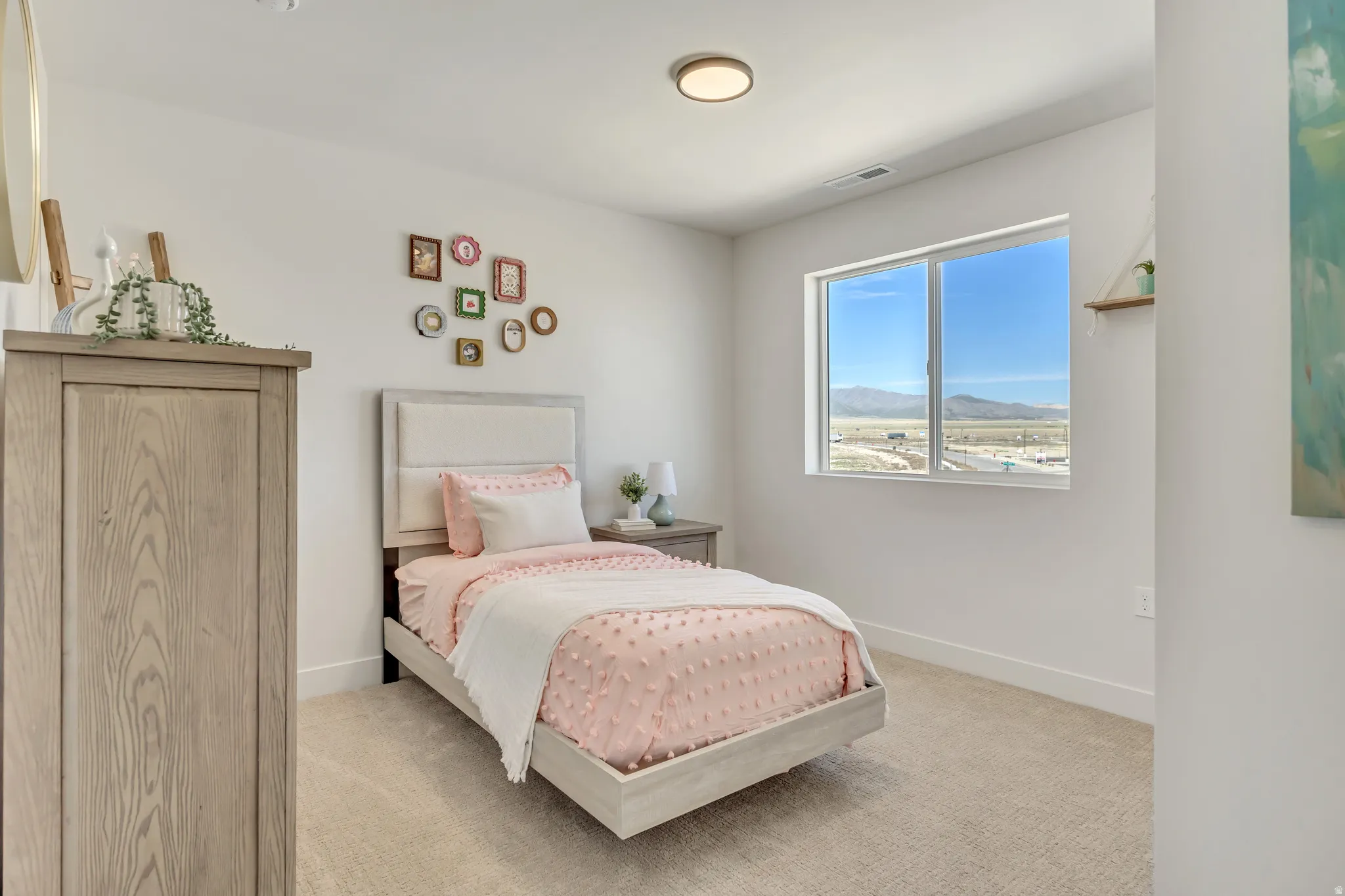Bedroom featuring a large window, neutral carpeting, light-toned walls, and a contemporary ceiling light fixture
