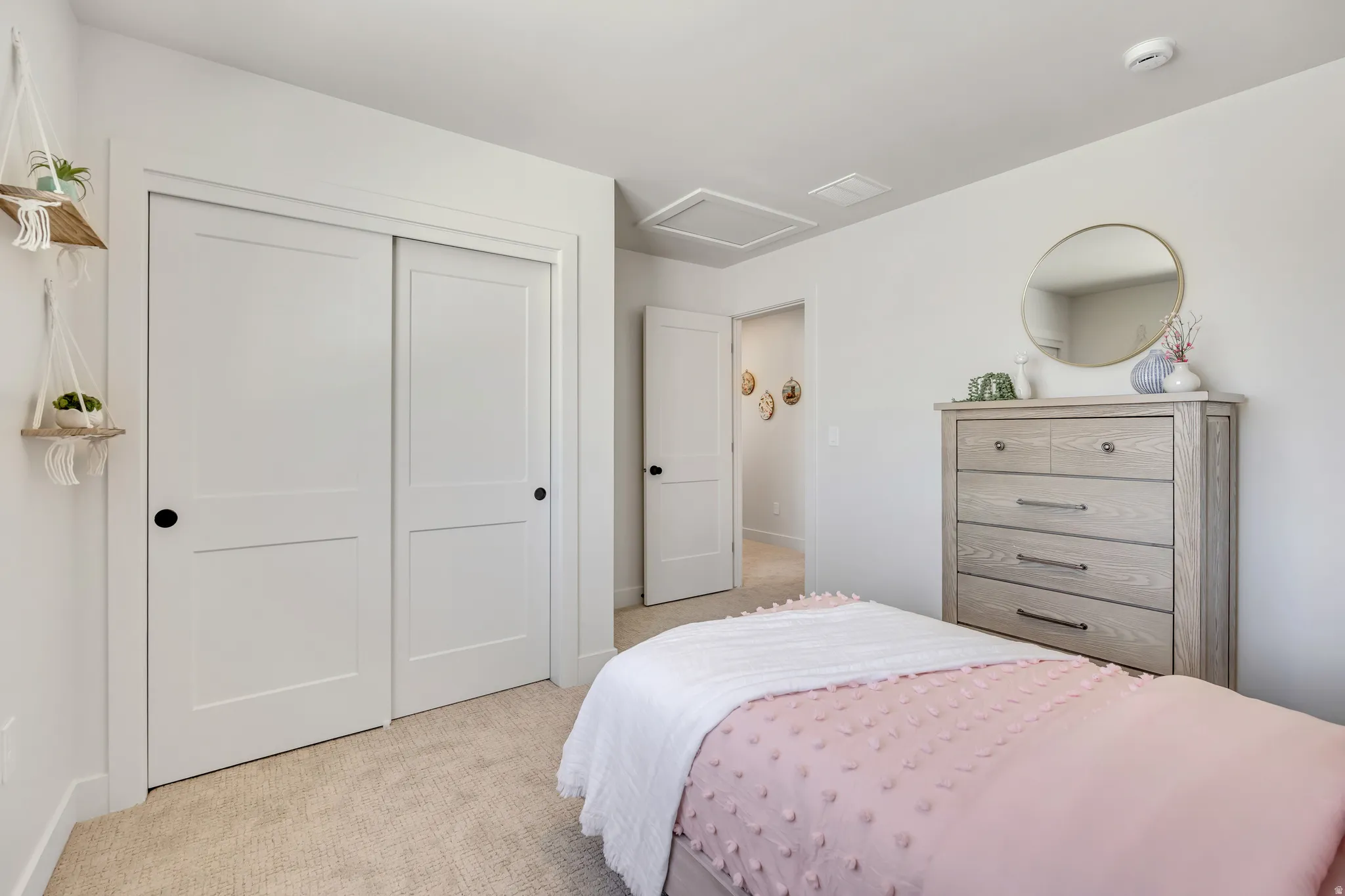 Light-colored wall-to-wall carpeting complements bright white walls and trim