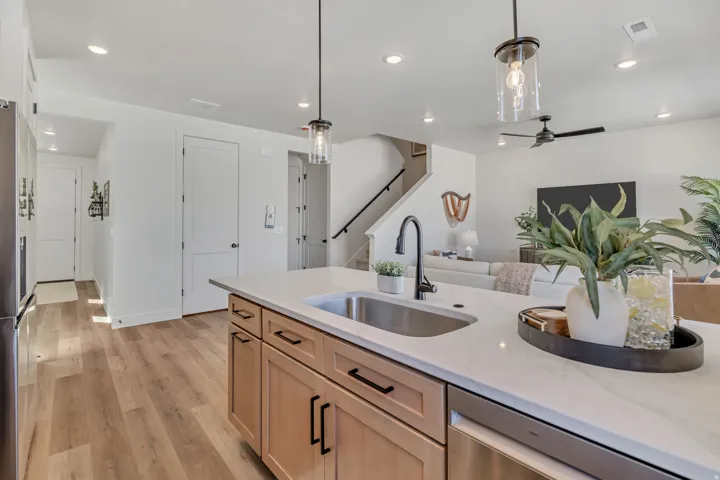 Kitchen island featuring a stainless steel undermount sink and matte black faucet