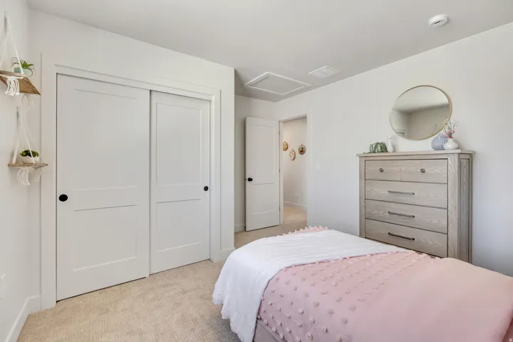 Light-colored wall-to-wall carpeting complements bright white walls and trim
