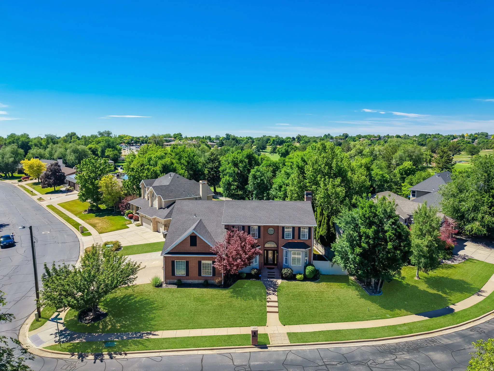 Traditional brick residence with a gabled roofline and multiple window dormers