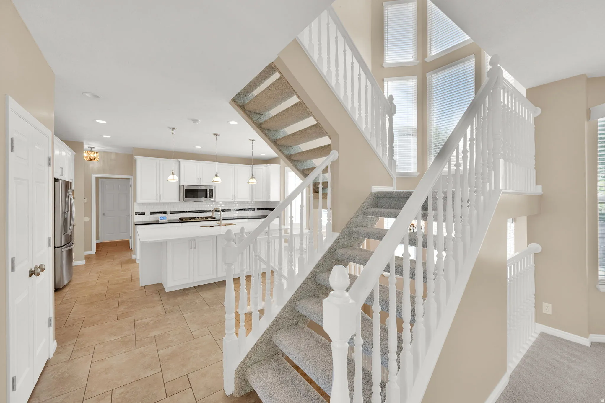 Multi-level staircase with white balusters and carpeted treads