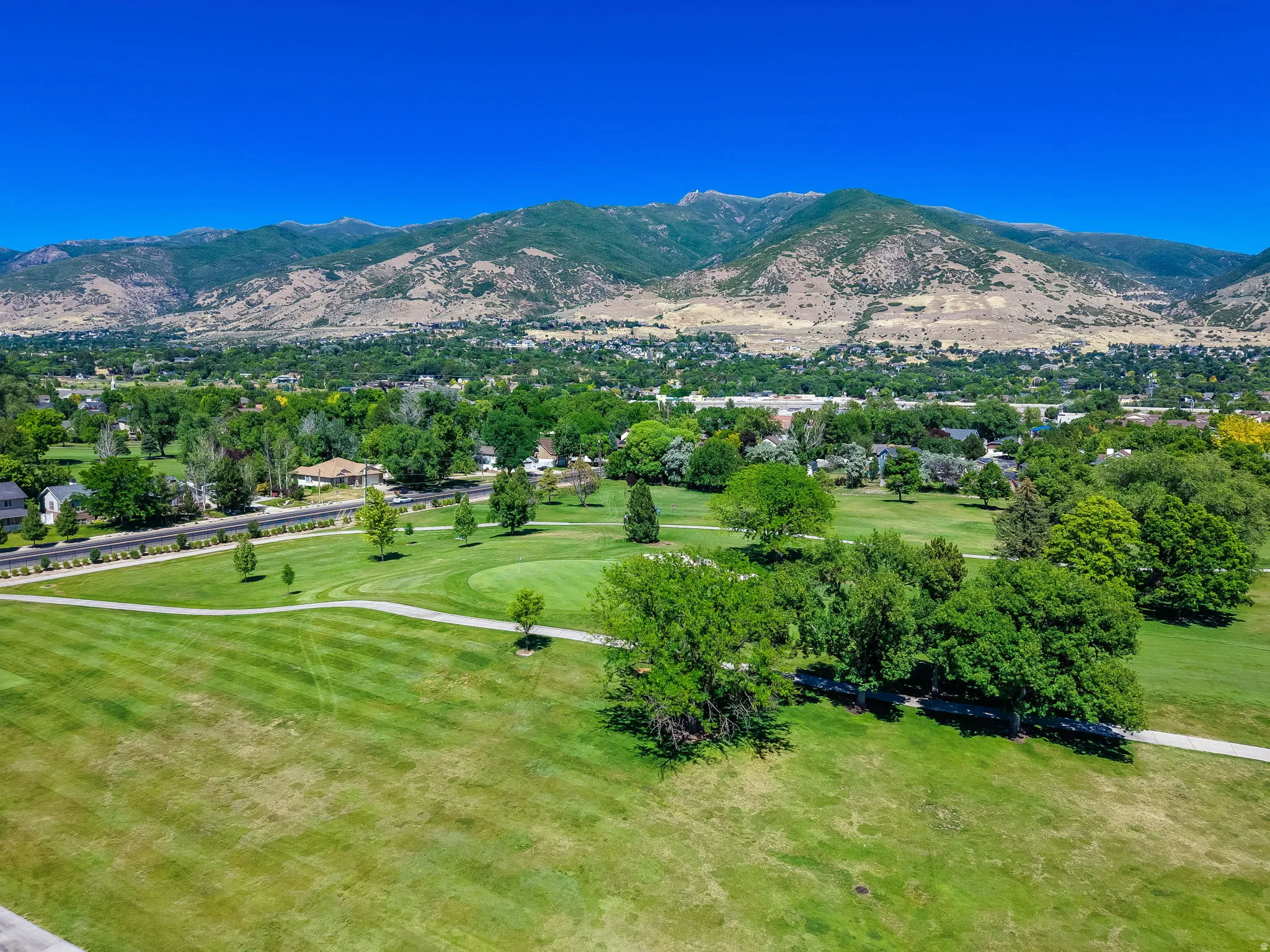 Expansive golf course grounds featuring manicured fairways and mature trees