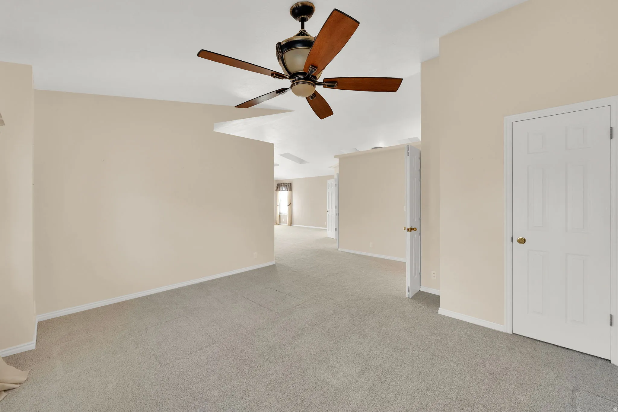 Spacious interior featuring neutral carpet flooring and light beige wall paint